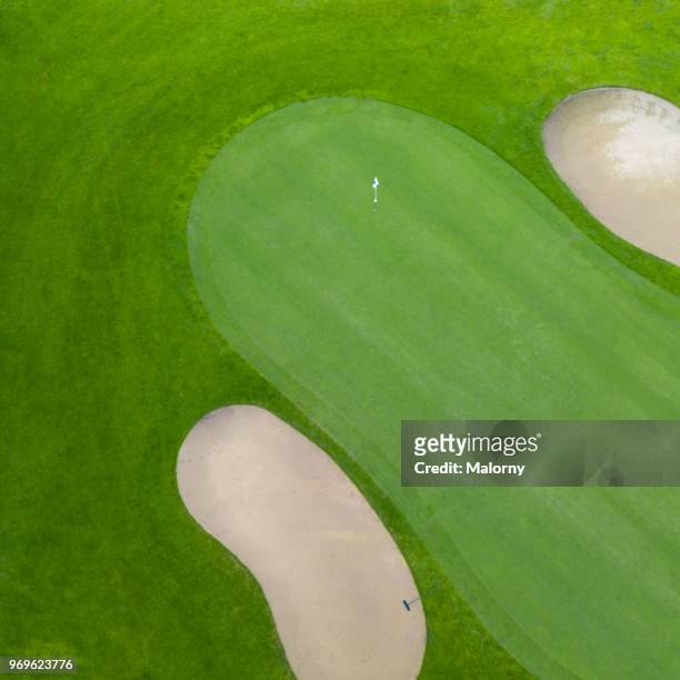 golf course. putting green and bunker. directly above, aerial view, drone point of view - golfplatz-green stock-fotos und bilder