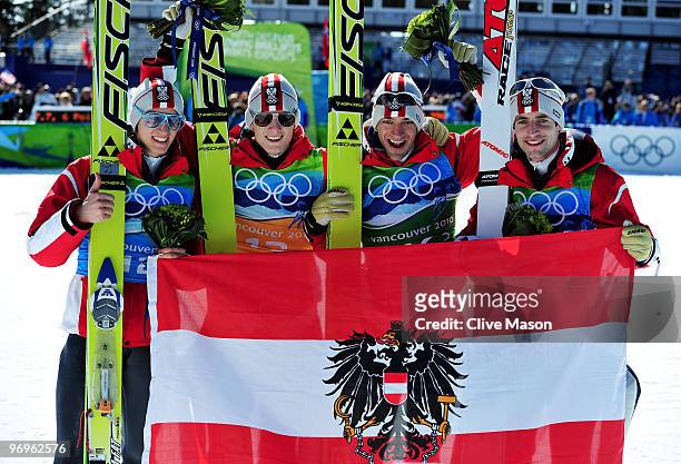 Wolfgang Loitzl, Andreas Kofler, Thomas Morgenstern and Gregor Schlierenzauer of Austria celebrate their gold medal in the men's ski jumping team...