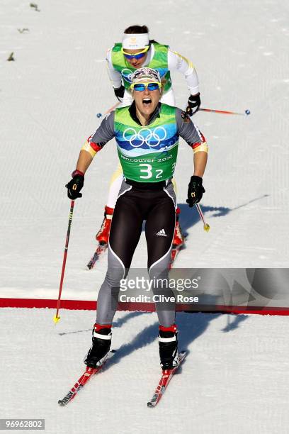 Claudia Nystad of Germany crosses the finish line ahead of Anna Haag of Sweden during the cross country skiing ladies team sprint final on day 11 of...
