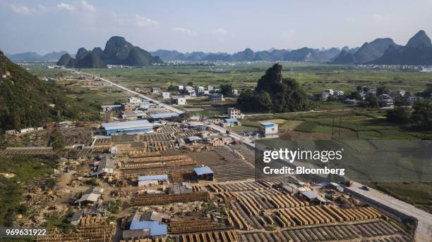 Sheets of eucalyptus wood dry on racks at a yard in this aerial photograph taken near Liuzhou, Guangxi province, China, on Tuesday, May 23, 2018....