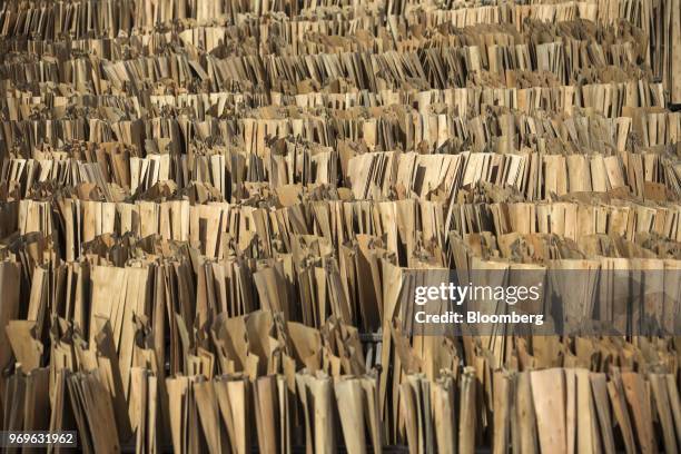 Sheets of eucalyptus wood dry on racks at a yard near Liuzhou, Guangxi province, China, on Tuesday, May 23, 2018. China is scheduled to release...