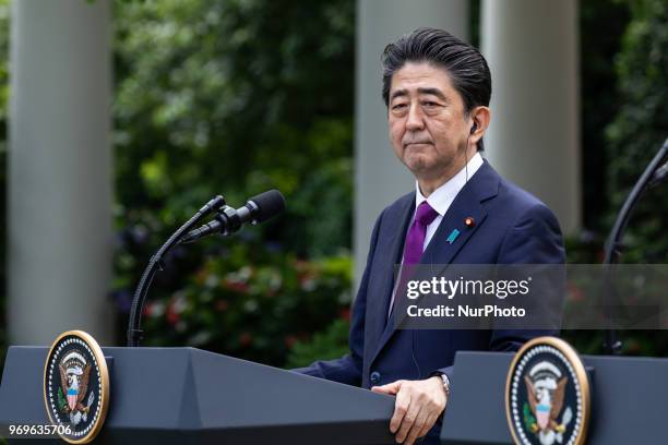 Prime Minister of Japan Shinz Abe listens to U.S. President Donald Trump at their joint press conference in the Rose Garden at the White House in...