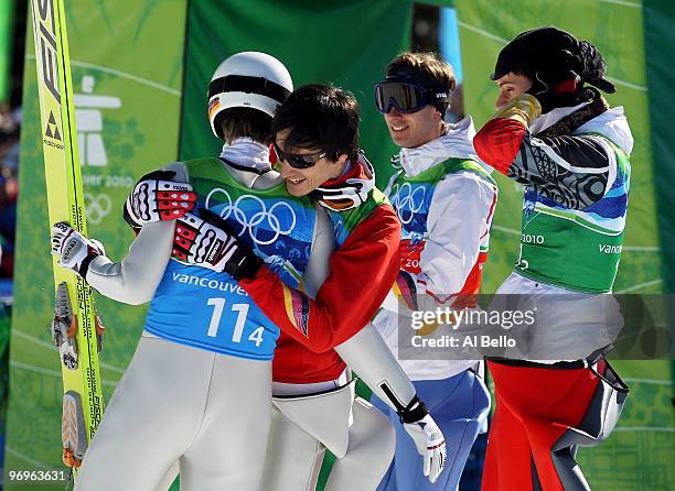 Members of the Germany ski jumping team celebrate their silver medal in the men's ski jumping team event on day 11 of the 2010 Vancouver Winter...