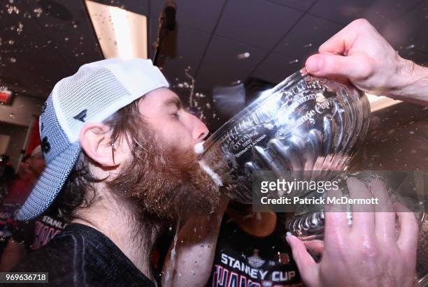 Goaltender Braden Holtby of the Washington Capitals drinks from the Stanley Cup in the locker room after his team defeated the Vegas Golden Knights...