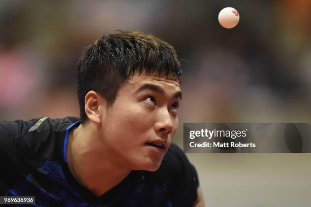 Jingkun Liang of China competes against Chun Ting Wong of Hong Kong during the men's singles round one match on day one of the ITTF World Tour LION...