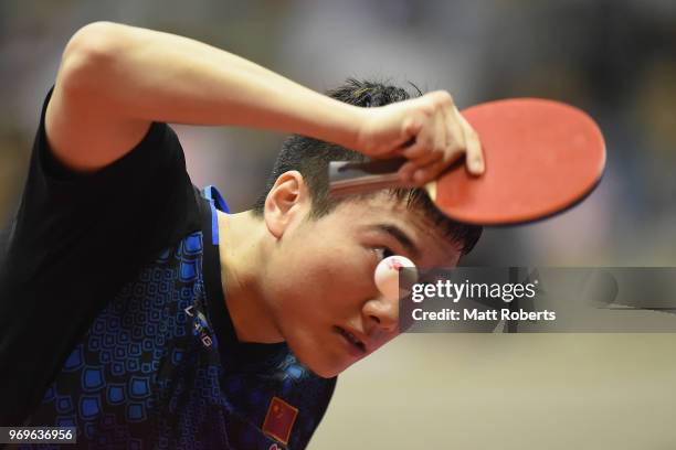 Jingkun Liang of China competes against Chun Ting Wong of Hong Kong during the men's singles round one match on day one of the ITTF World Tour LION...