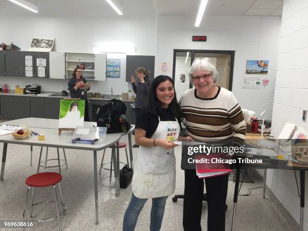 Bianca Quintanilla, a student at East Aurora High School, spends some time with Kendra Noll of the Woman's Club of Aurora. Quintanilla won an art...