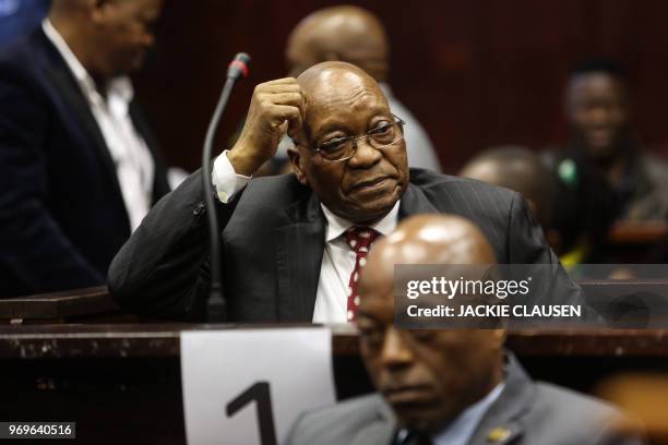 Former South African President Jacob Zuma reacts as he sits at the dock at the Durban Magistrate Court in Durban, on June 8, 2018 during a hearing to...