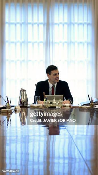 Spanish Prime Minister Pedro Sanchez chairs the new government's first cabinet meeting at La Moncloa palace in Madrid on June 8, 2018. - King Felipe...