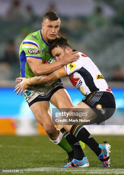 Jack Wighton of the Raiders is tackled by James Maloney of the Panthers during the round 14 NRL match between the Canberra Raiders and the Penrith...