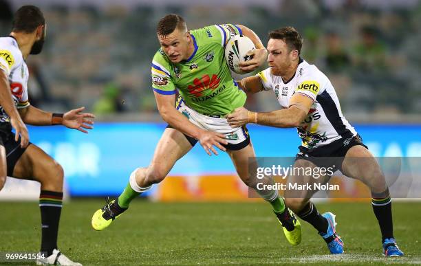 Jack Wighton of the Raiders is tackled by James Maloney of the Panthers during the round 14 NRL match between the Canberra Raiders and the Penrith...