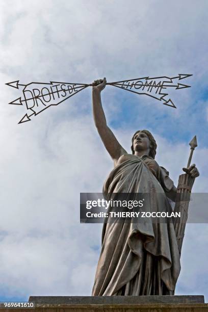 Picture taken on May 2, 2018 shows the Human Rights statue in Aurillac. - The initiative "A roof, a job" helps former homeless people to make a fresh...