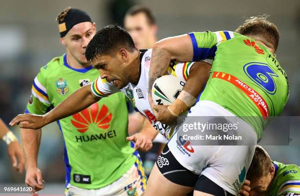 Tyrone Peachey of the Panthers is tackled during the round 14 NRL match between the Canberra Raiders and the Penrith Panthers at GIO Stadium on June...