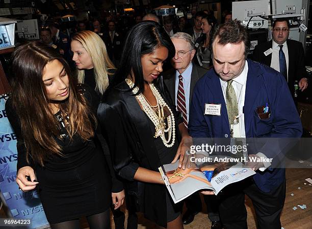 Sports Illustrated Swimsuit models Jessica Gomes and Jessica White talk to a fan at the closing bell at the New York Stock Exchange on February 22,...