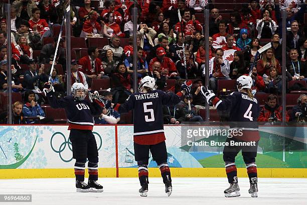 Caitlin Cahow of the United States celebrates scoring the fourth USA goal with Karen Thatcher and Angela Ruggiero during the ice hockey women's...