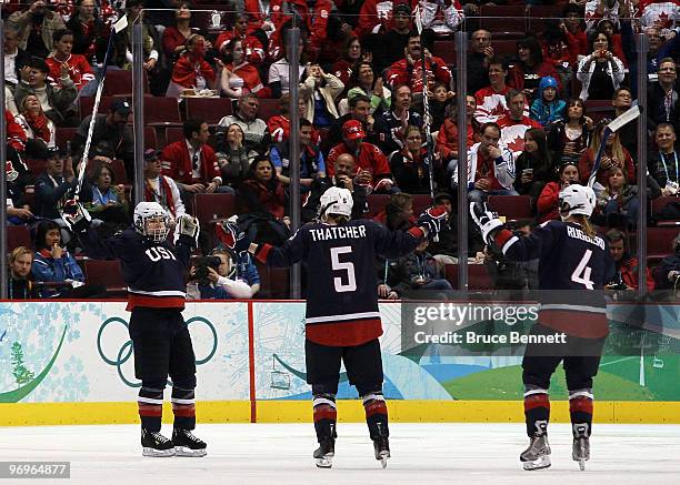 Caitlin Cahow of the United States celebrates scoring the fourth USA goal with Karen Thatcher and Angela Ruggiero during the ice hockey women's...