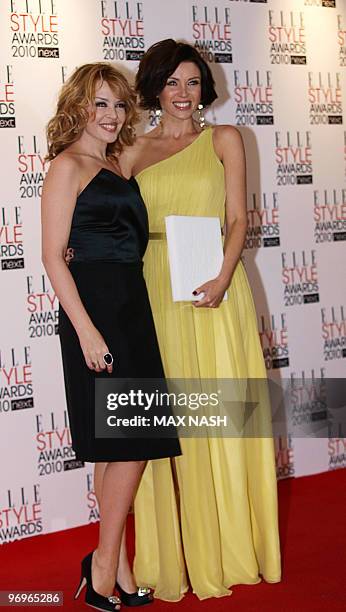 Australian pop star Kylie Minogue poses with her sister Dannii Minogue, winner of the Television Star award, at the 2010 Elle Awards in central...