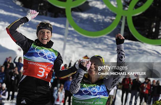 Germany's Claudia Nystad and Evi Sachenbacher-Stehle pose on the podium after the women's cross country skiing team sprint free at Whistler Olympic...