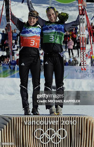 Germany's Claudia Nystad and Evi Sachenbacher-Stehle pose on the podium after the women's cross country skiing team sprint free at Whistler Olympic...