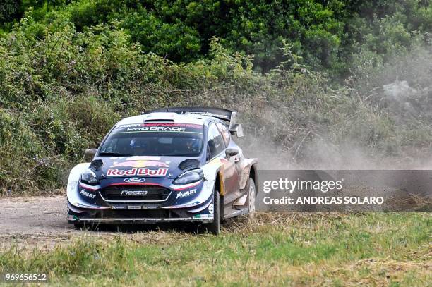 French driver Sebastien Ogier and co-driver Julien Ingrassia drive their Ford Fiesta WRC, near Castelsardo village, on the second day of the 2018 FIA...