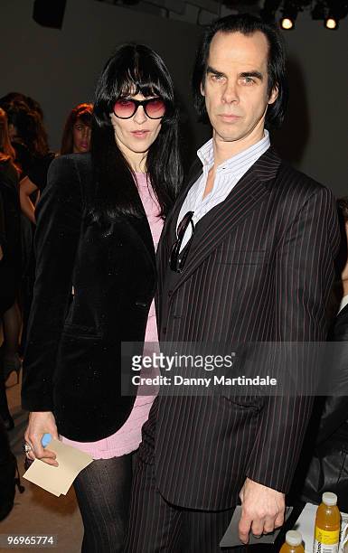 Nick Cave and wife Susie Bick pose on the front row at the Pam Hogg show for London Fashion Week Autumn/Winter 2010 at On|Off on February 22, 2010 in...