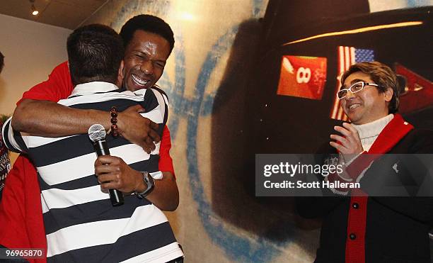 United States Olympic gold medal speed skater Shani Davis hugs his coach Ryan Shimabukuro after presenting him and Jimmy Jang with the coaches medal...