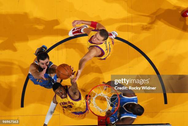 Watson and Andris Biedrins of the Golden State Warriors team up for a rebound against Peja Stojakovic of the New Orleans Hornets during the game at...