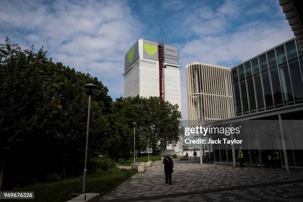 Banner of support, featuring green hearts sits on top of the outside of Grenfell Tower on June 8, 2018 in London, England. June 14, 2018 marks the...