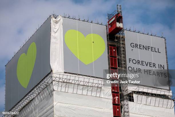 Banner of support, featuring green hearts sits on top of the outside of Grenfell Tower on June 8, 2018 in London, England. June 14, 2018 marks the...