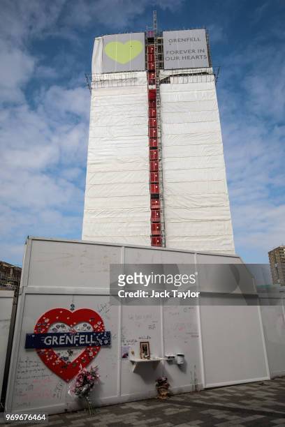 Banner of support, featuring green hearts sits on top of the outside of Grenfell Tower on June 8, 2018 in London, England. June 14, 2018 marks the...