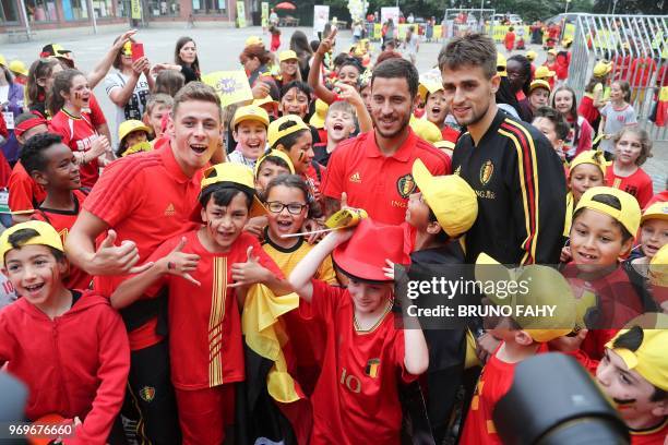 Belgium's midfielder Thorgan Hazard, Belgium's forward Eden Hazard and Belgium's Adnan Januzaj meet pupils of the Ecole Fondamentale de Clabecq in...