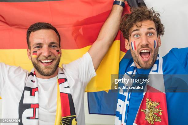 soccer fans cheering for national teams at world cup championship - soccer scarf stock pictures, royalty-free photos & images