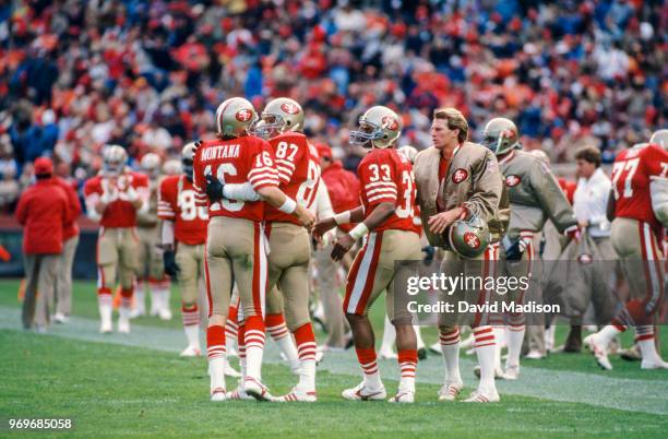 Dwight Clark of the San Francisco 49ers congratulates Joe Montana after a touchdown pass during a National Football League game against the Kansas...