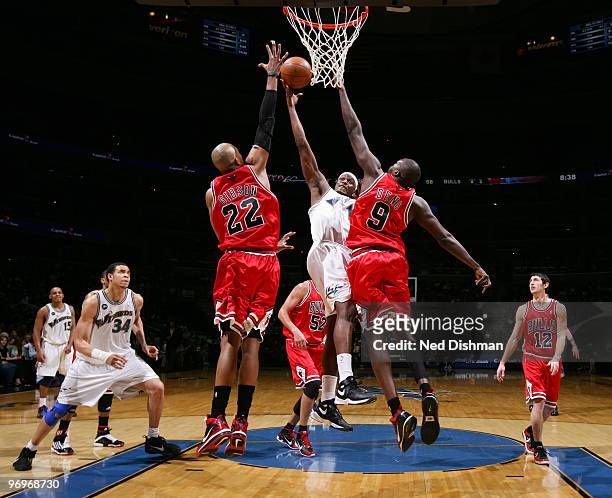 Al Thornton of the Washington Wizards shoots against Taj Gibson and Luol Deng of the Chicago Bulls at the Verizon Center on February 22, 2010 in...