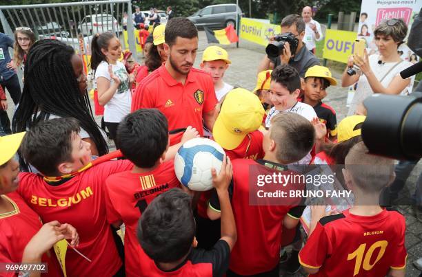 Belgium's forward Eden Hazard signs autographs of pupils of the Ecole Fondamentale de Clabecq in Clabecq, Belgium on June 8, 2018. - The Red Devils...