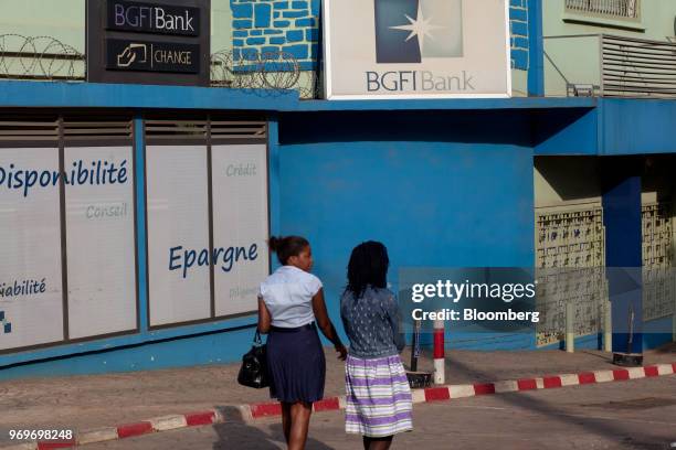 Pedestrians walk past a BGFIBank Cameroun SA bank branch on Monte Ane Rouge in Yaounde, Cameroon, on Tuesday, June 5, 2018. Cameroon adjusted its...