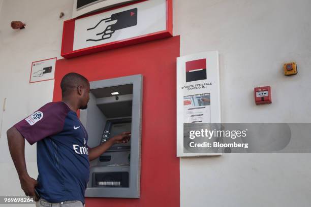 Customer uses an automated teller machine at a branch of Societe Generale de Banques au Cameroun in Yaounde, Cameroon, on Tuesday, June 5, 2018....