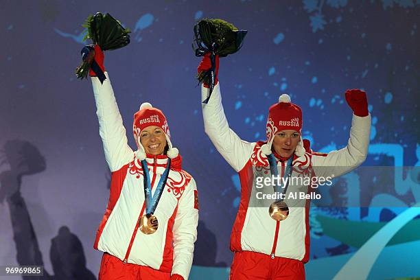 Natalia Korosteleva and Irina Khazova of Russia receive the bronze medal during the medal ceremony for the women's team sprint cross-country skiing...