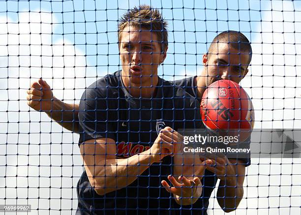 Ryan Houlihan of the Blues handballs during a Carlton Blues AFL training session at Visy Park on February 23, 2010 in Melbourne, Australia.