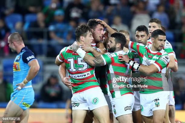 Sam Burgess of the Rabbitohs celebrates a try with team mates during the round 14 NRL match between the Gold Coast Titans and the South Sydney...