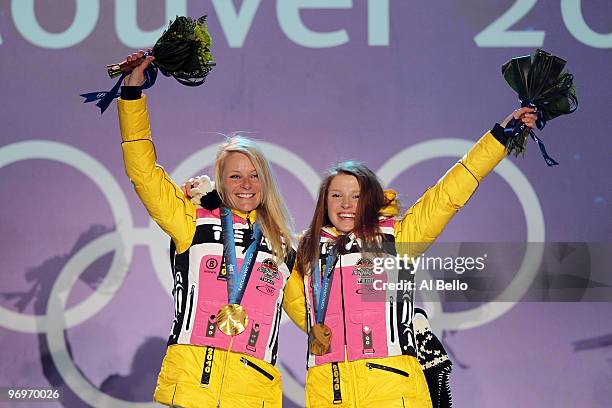 Claudia Nystad and Evi Sachenbacher-Stehle of Germany receive the gold medal during the medal ceremony for the women's team sprint cross-country...