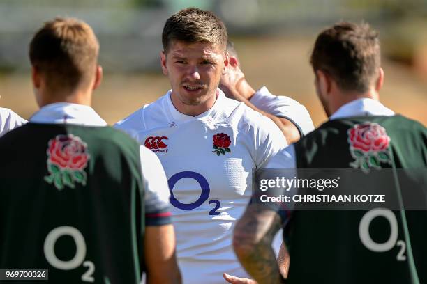 England's scrum-half and captain Owen Farrell speaks with teammates during the England's rugby team captain's run and training session June 8, 2018...