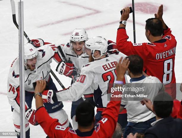 John Carlson, Andre Burakovsky and Lars Eller of the Washington Capitals celebrate after Burakovsky assisted Eller on a third-period goal against the...