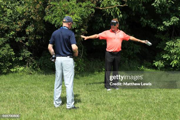 Miguel Ángel Jiménez of Spain speaks to referee Ben Groutage after loosing his ball on 9th hole during day two of The 2018 Shot Clock Masters at...