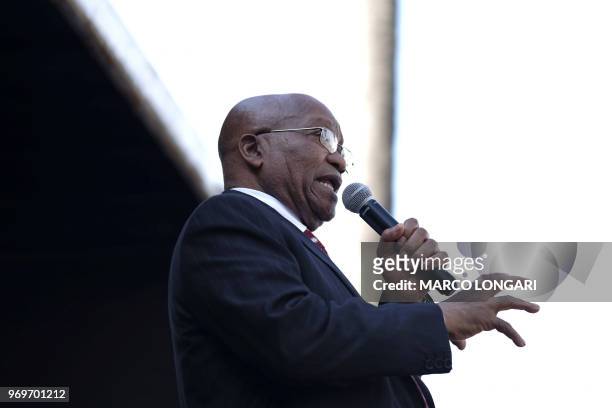 Former South African President Jacob Zuma addresses supporters outside the Durban Magistrate Court in Durban, on June 8, 2018 after the judge...