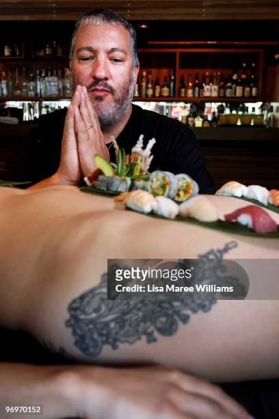 New York artist Spencer Tunick eats sushi from a nude model during a press conference at the Toko Restaurant & Bar on February 23, 2010 in Sydney,...