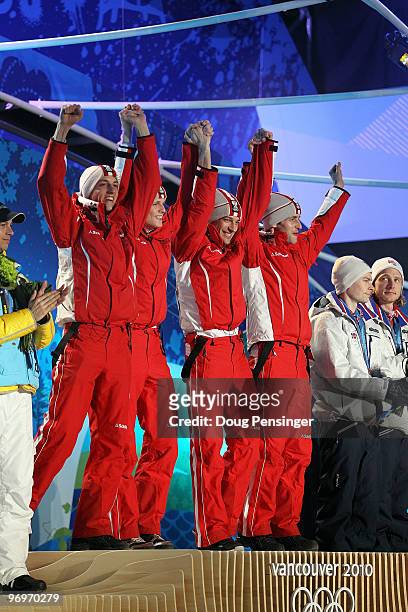 The Austrian team receive the gold medal during the medal ceremony for the men's team ski jumping on day 11 of the Vancouver 2010 Winter Olympics at...