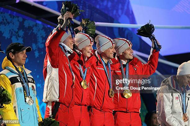 The Austrian team receive the gold medal during the medal ceremony for the men's team ski jumping on day 11 of the Vancouver 2010 Winter Olympics at...