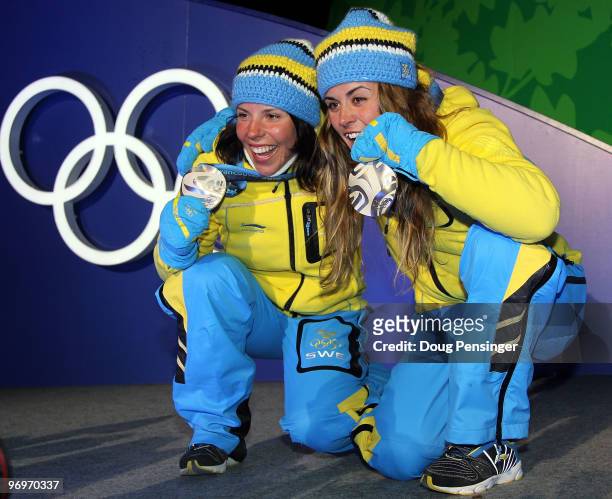 Charlotte Kalla and Anna Haag of Sweden receive the silver medal during the medal ceremony for the women's team sprint cross-country skiing on day 11...
