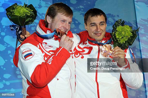 Alexsandr Zubkov and Alexey Voevoda of Russia receive the bronze medal during the medal ceremony for the men's two-man bobsleigh on day 11 of the...